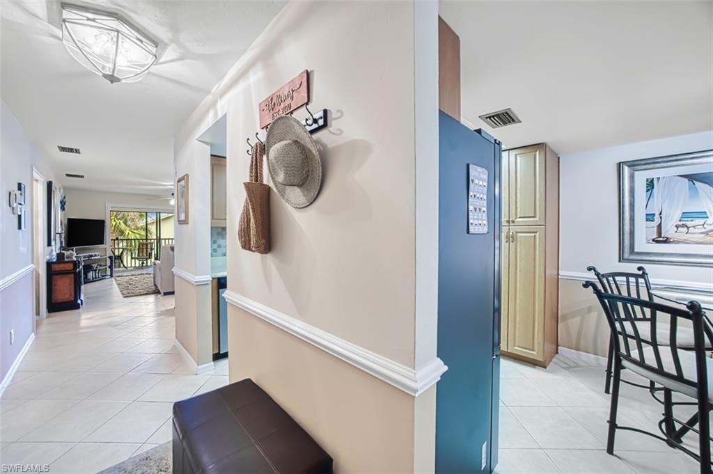 Hallway with light tile patterned flooring