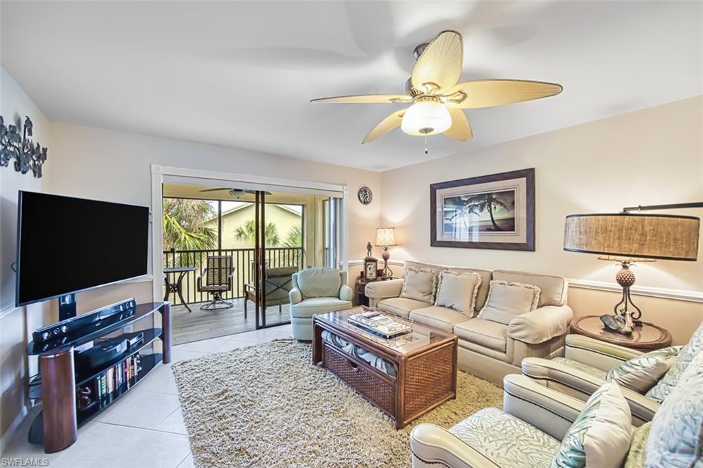 Living area featuring light tile patterned flooring and ceiling fan