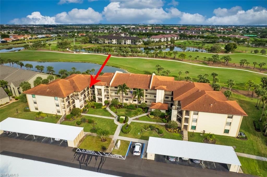 Aerial perspective of suburban area featuring a large body of water and a local golf course