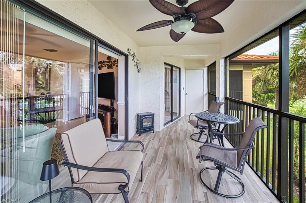 Sunroom / solarium featuring a wood stove and plenty of natural light