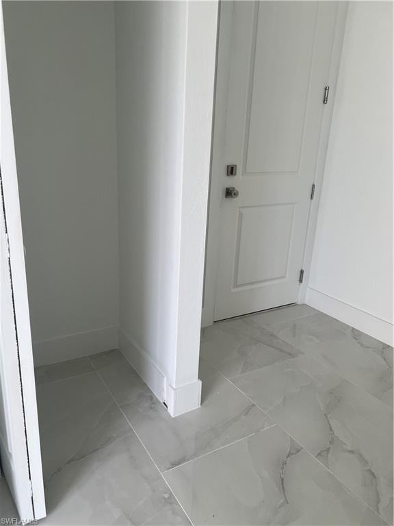 Corridor with light marble finish flooring