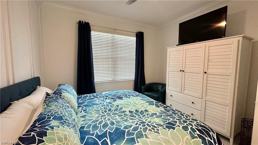 Bedroom featuring ceiling fan, crown molding, and multiple windows