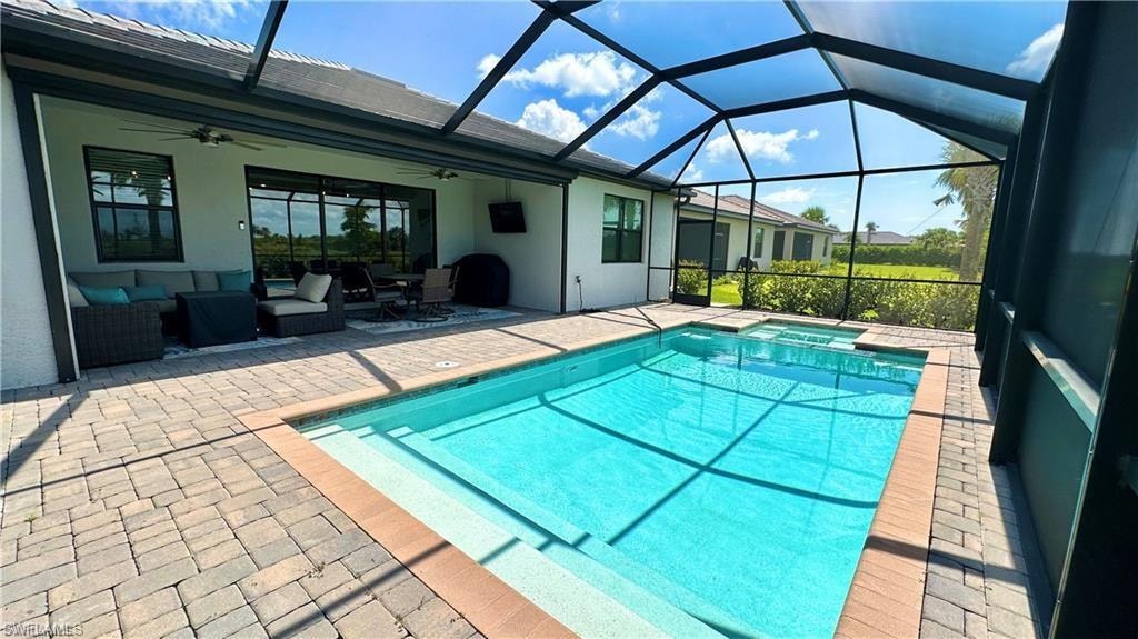 View of pool featuring a patio, a lanai, an outdoor hangout area, and ceiling fan