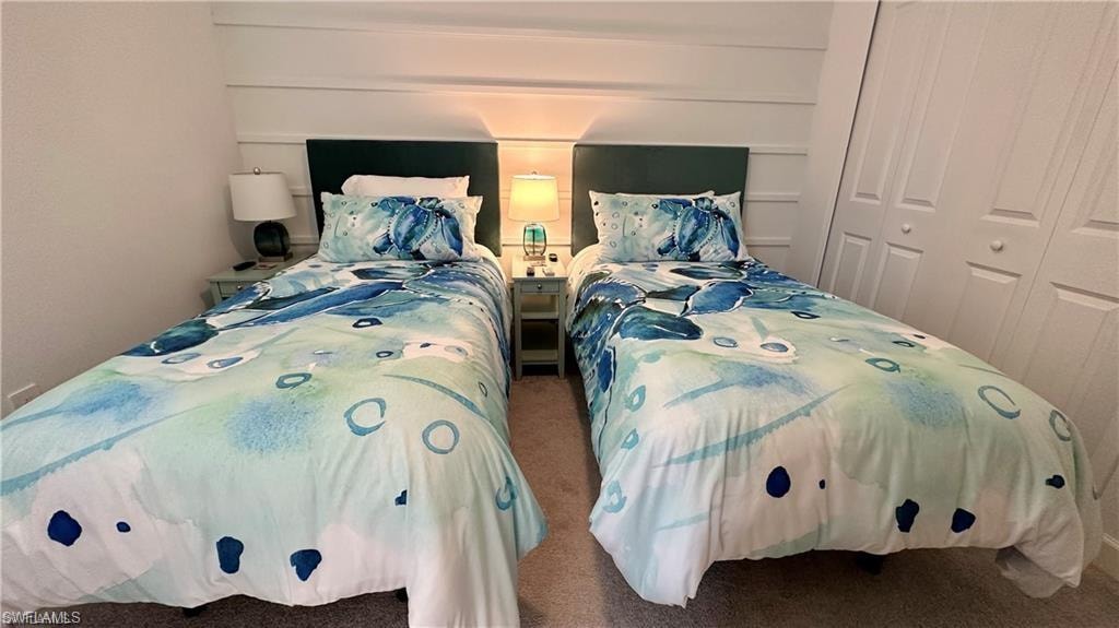 Carpeted bedroom with a closet
