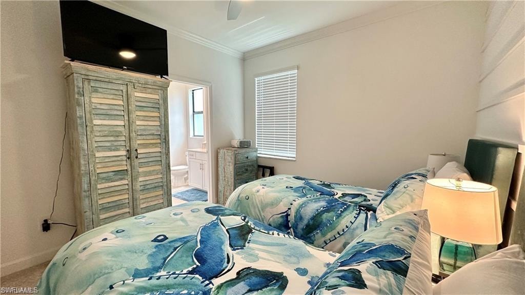 Bedroom featuring connected bathroom, ornamental molding, carpet floors, and ceiling fan