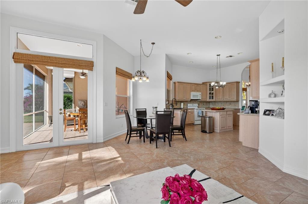 Living room with a ceiling fan, a chandelier, plenty of natural light, and recessed lighting
