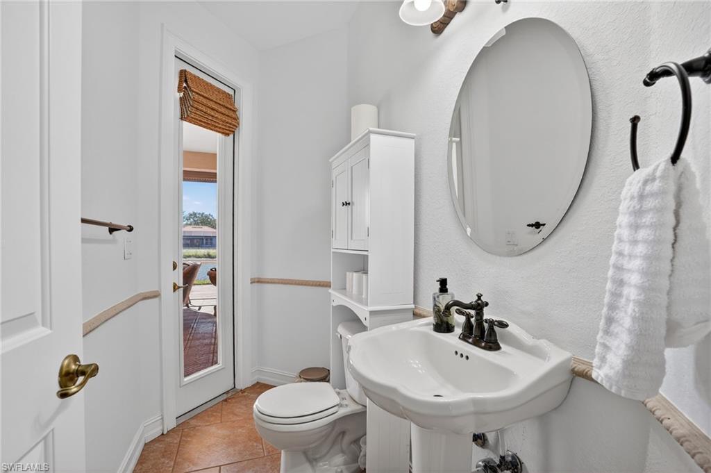 Bathroom featuring toilet and light tile patterned floors