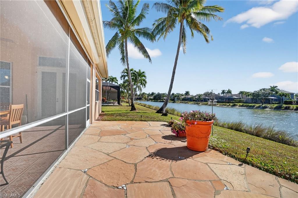 View of patio / terrace with a lanai, a water view, and a sunroom
