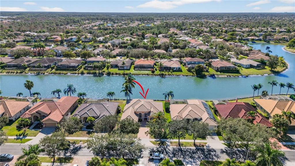 Aerial view of residential area featuring a large body of water
