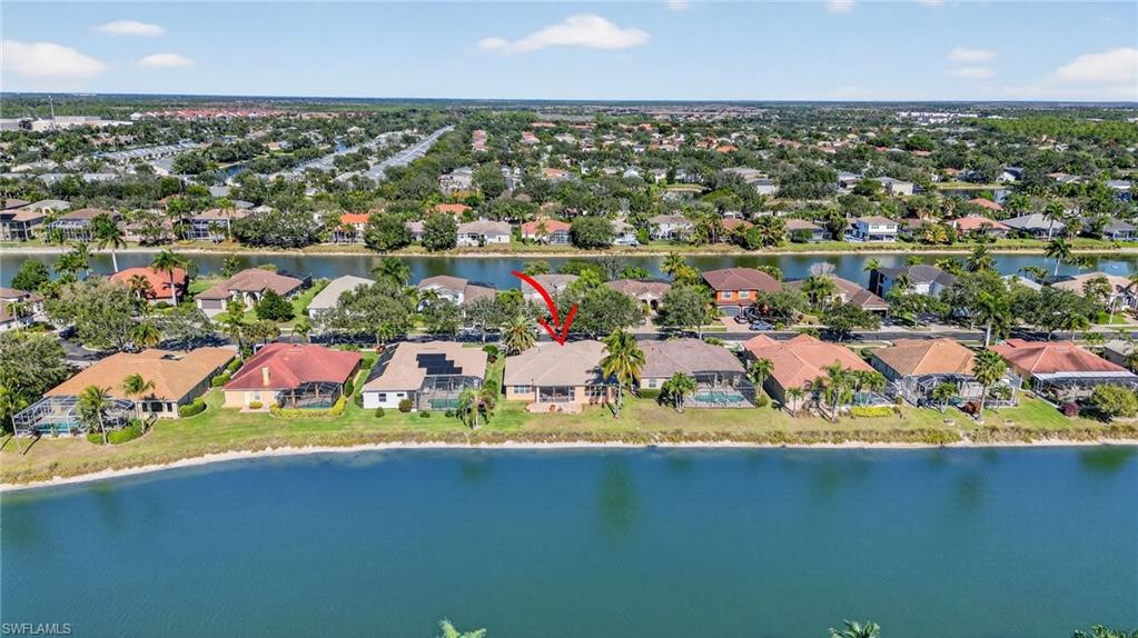 Aerial perspective of suburban area featuring a large body of water
