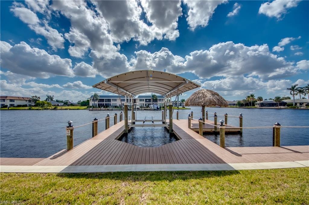 Dock with a water view, a yard, and boat lift
