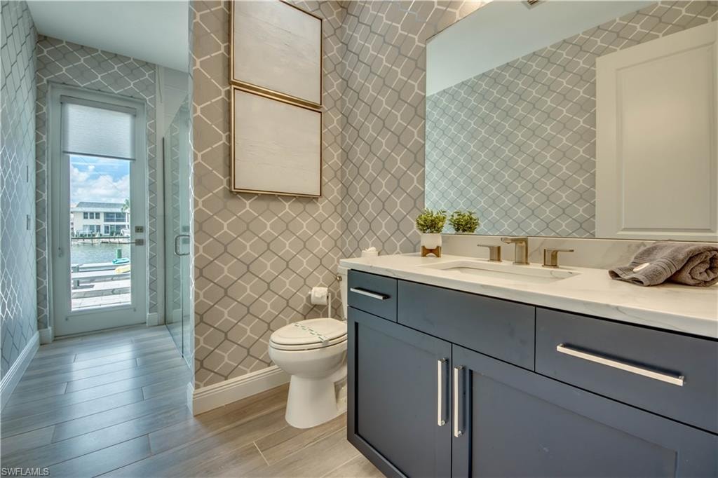 Bathroom featuring vanity, wood tiled floors, and tile walls