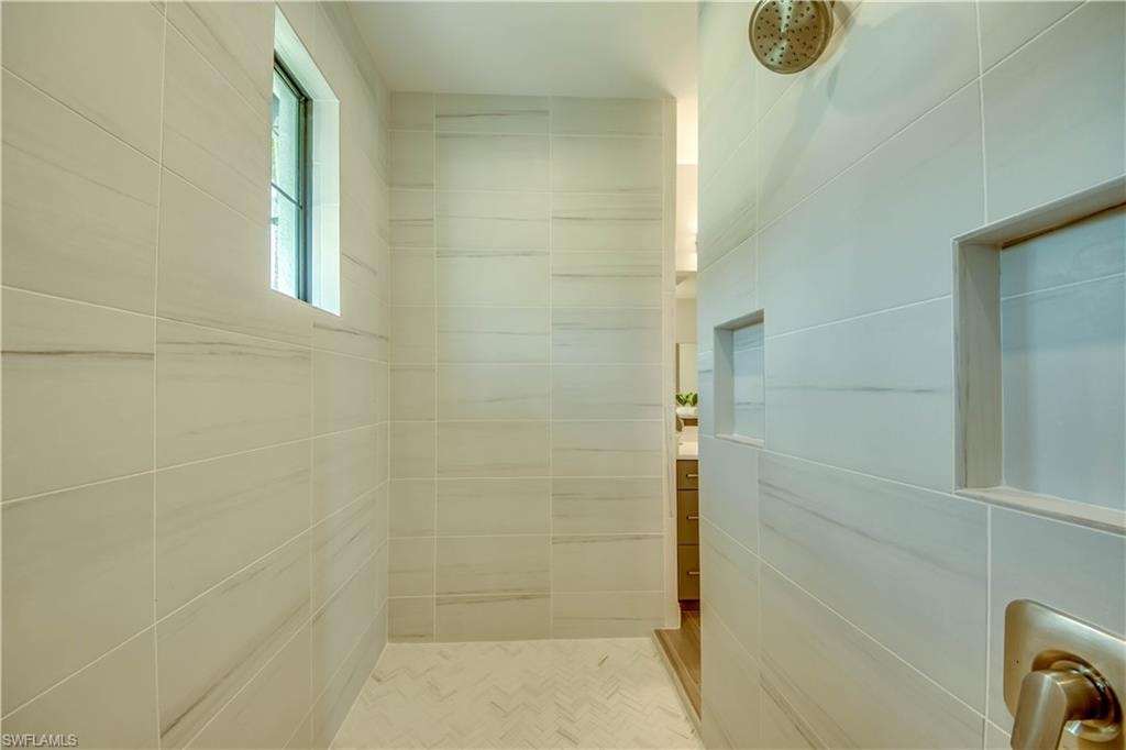 Bathroom featuring vanity, a freestanding tub, and wood finish floors