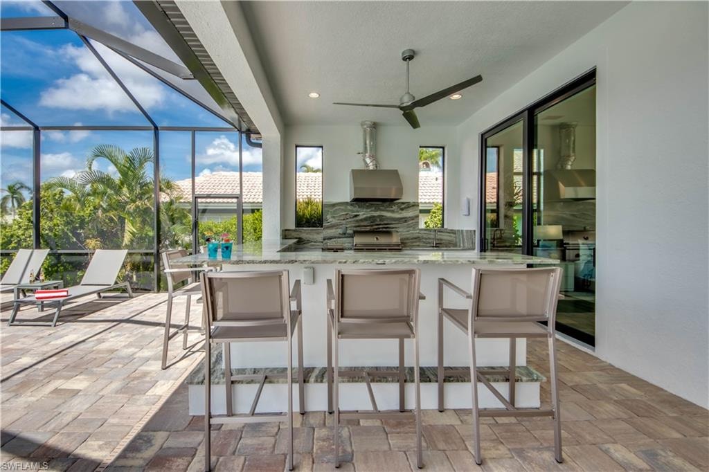 View of patio featuring exterior kitchen and a ceiling fan