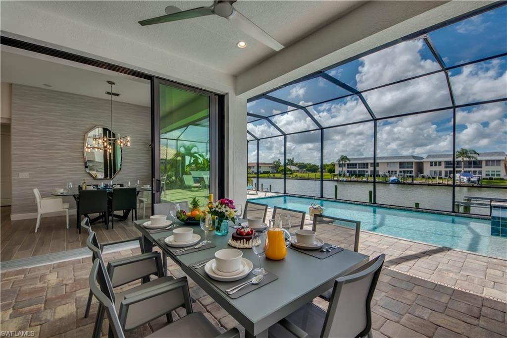 Dining area with a sunroom and a water view