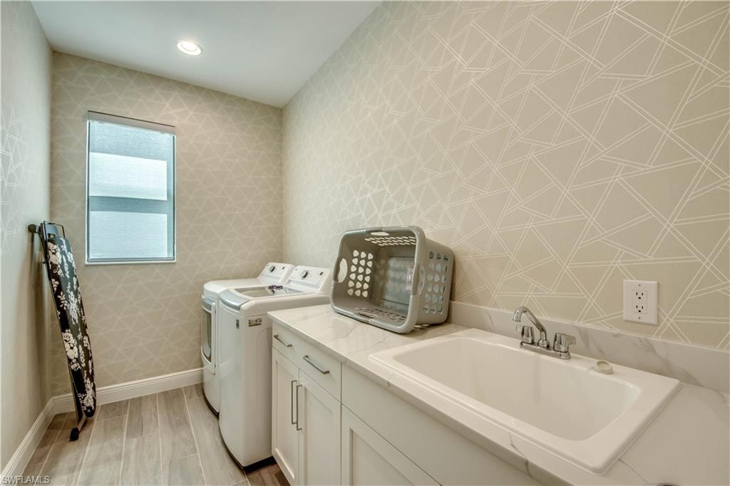 Full bathroom featuring vanity, a shower stall, and wood tiled floors