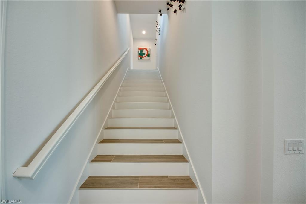 Workout area featuring healthy amount of natural light and light wood finished floors