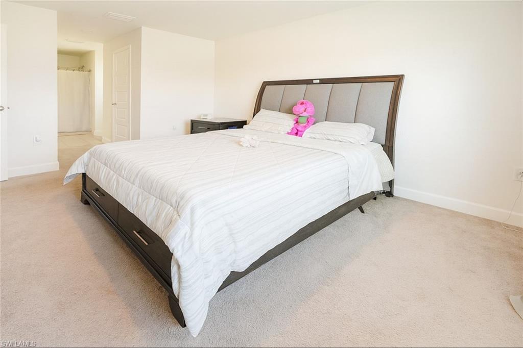 Bedroom featuring light colored carpet