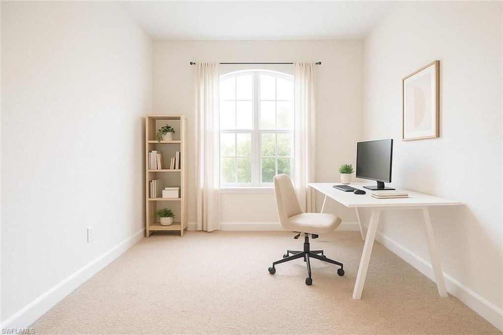 Office space with light colored carpet and baseboards