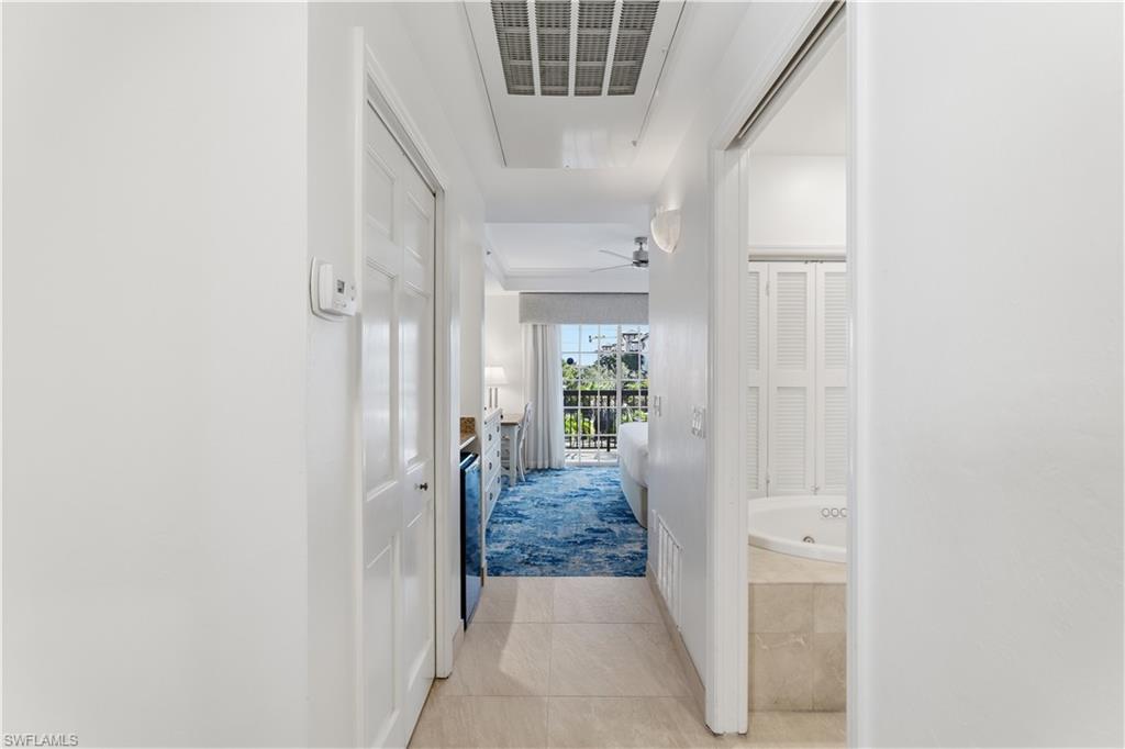 Hallway featuring light tile patterned floors