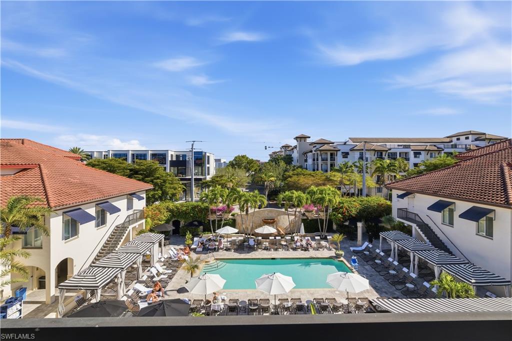 Community pool featuring a pergola, a patio area, and a residential view