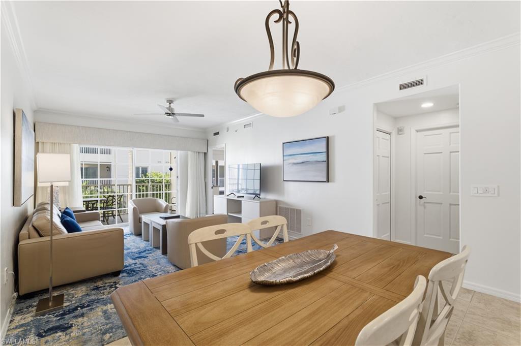 Dining room with crown molding and a ceiling fan