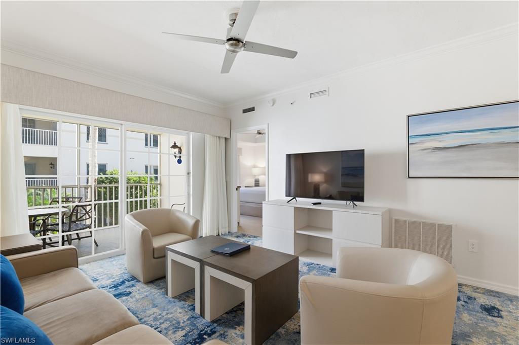 Living area with ornamental molding and ceiling fan
