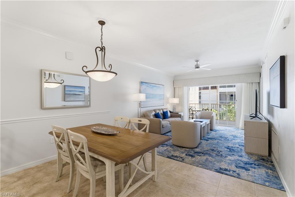 Dining area with ornamental molding, ceiling fan, and light tile patterned floors