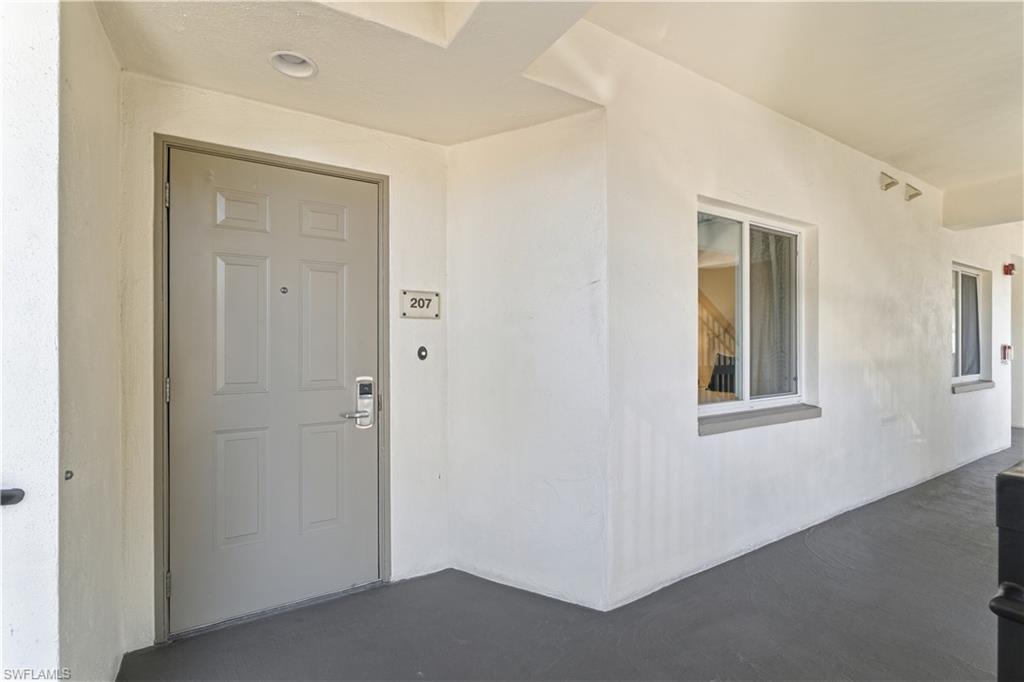View of exterior entry with stucco siding