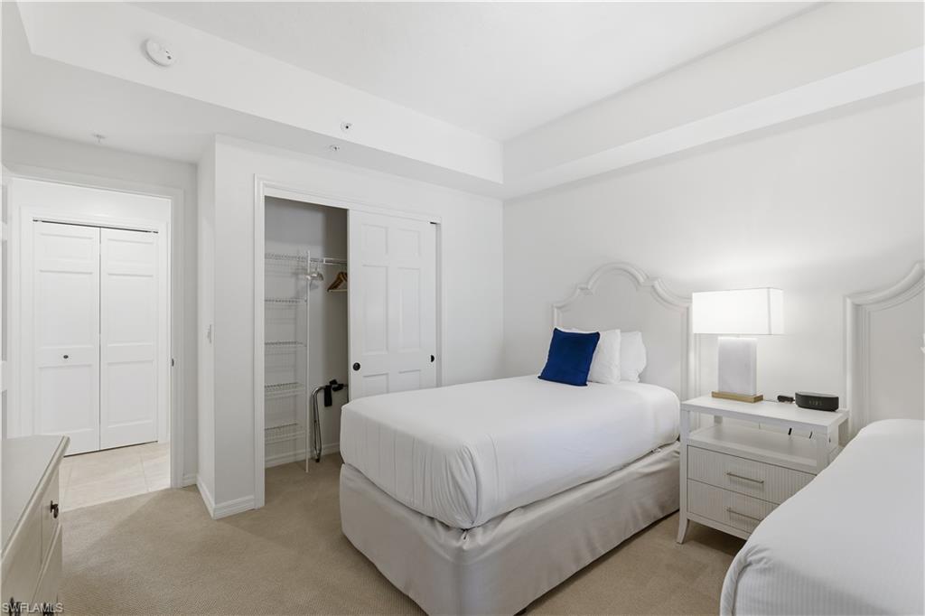 Bedroom with a closet and light colored carpet