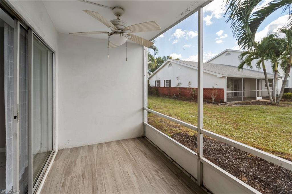 Unfurnished sunroom featuring a ceiling fan