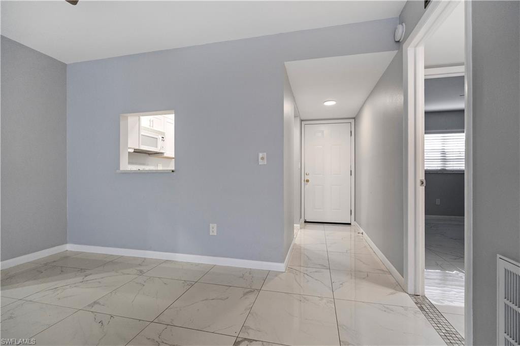 Unfurnished room featuring light marble finish flooring