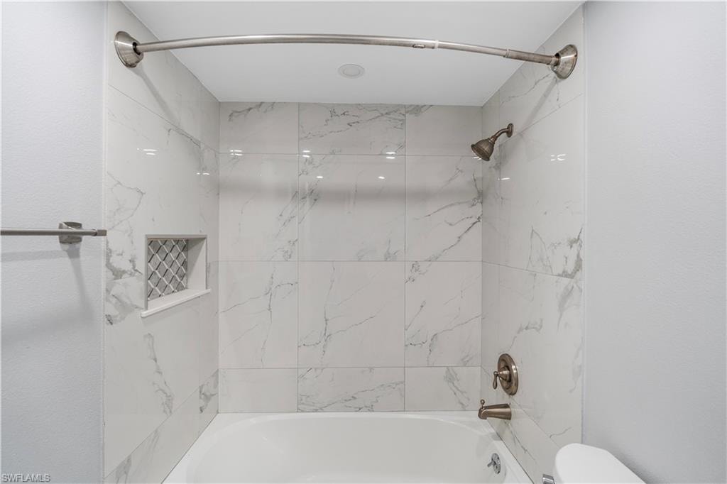 Full bathroom featuring bathing tub / shower combination and toilet