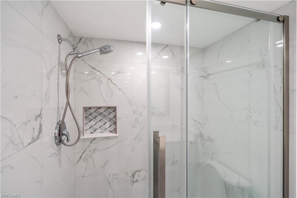 Bathroom featuring a marble finish shower