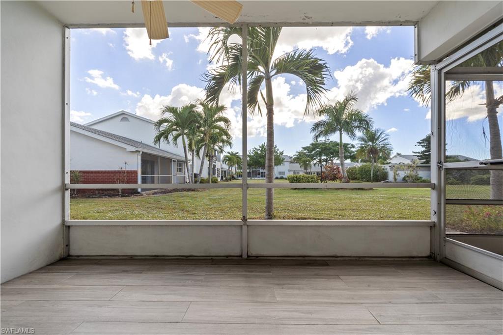 Unfurnished sunroom featuring plenty of natural light and a ceiling fan