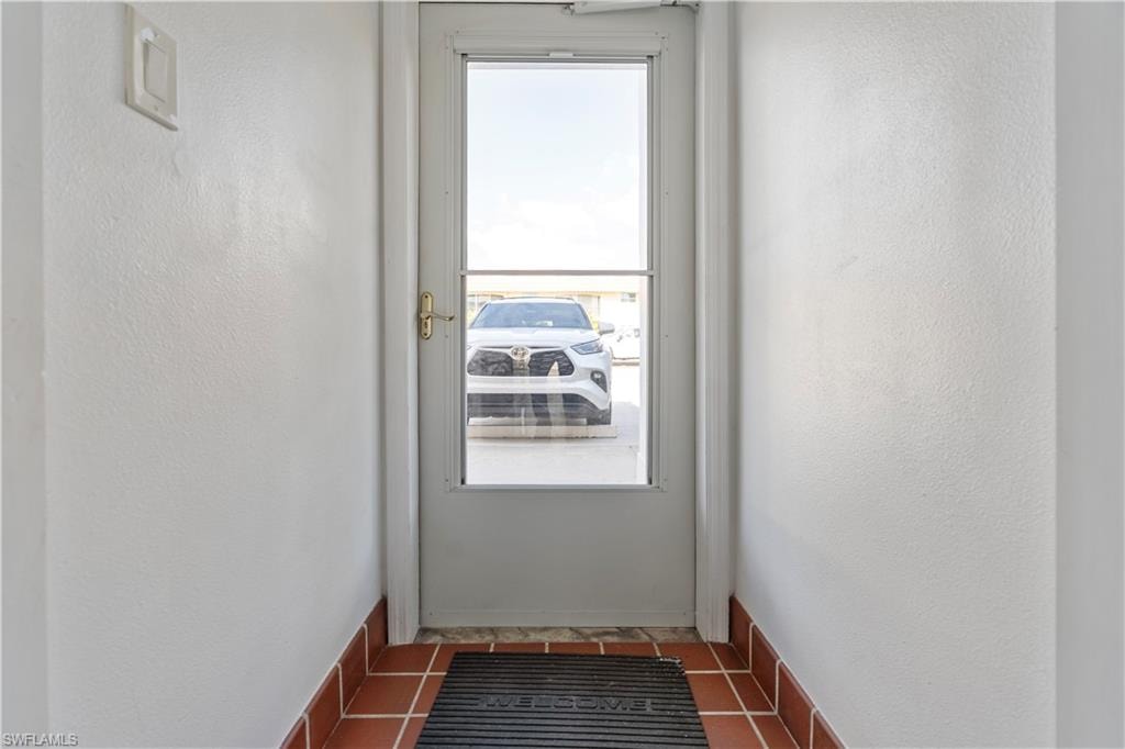 Doorway featuring a textured wall