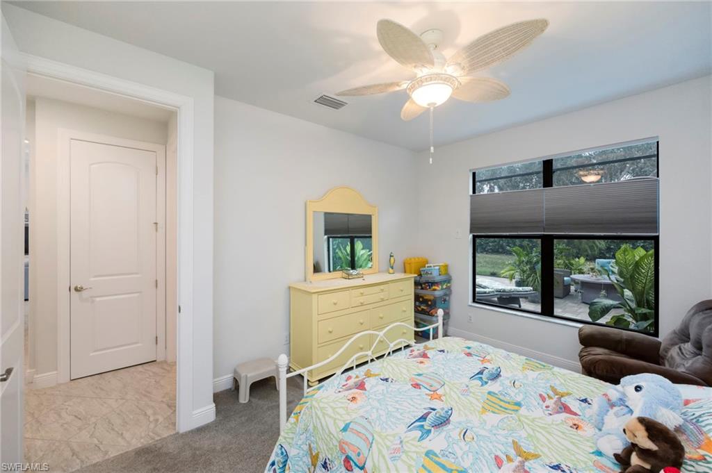 Bedroom with a ceiling fan and baseboards