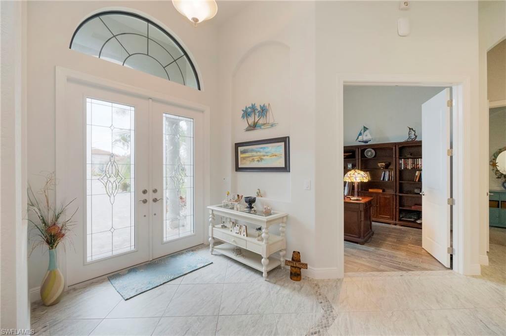 Entryway featuring french doors and a towering ceiling