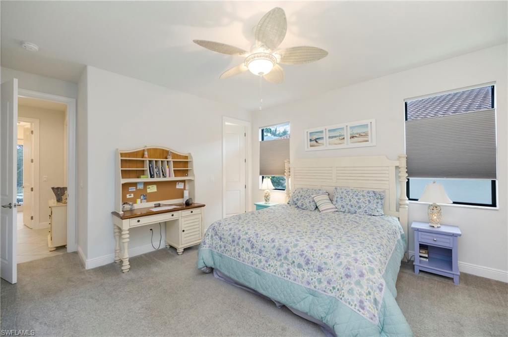 Bedroom with light colored carpet and ceiling fan
