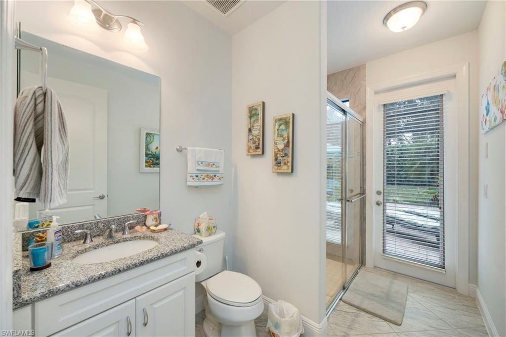 Bathroom featuring vanity and a stall shower