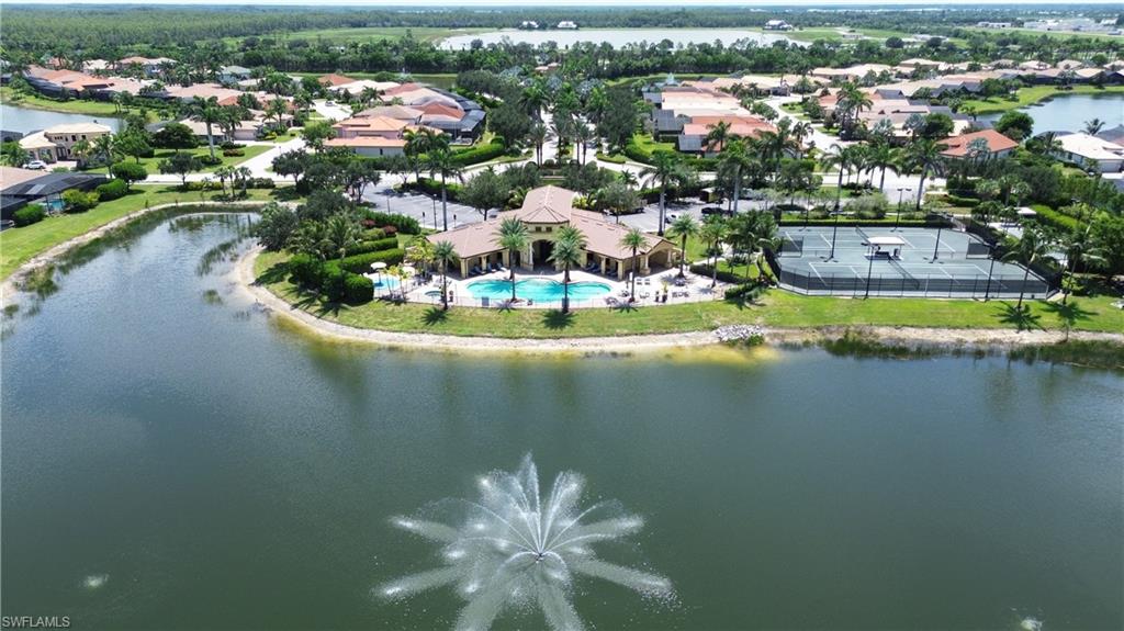 Aerial view of residential area featuring a large body of water and a pool area