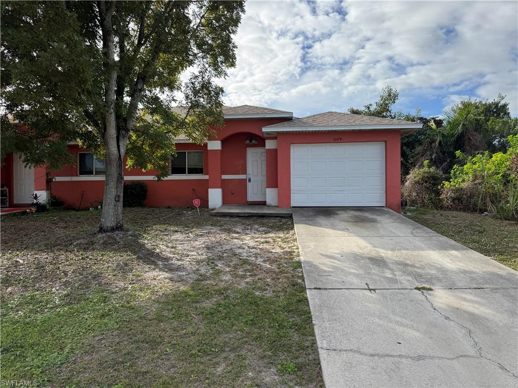 Front exterior featuring attached garage and driveway parking