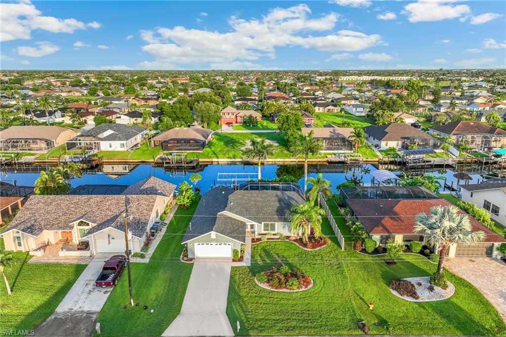 Aerial perspective of suburban area with a nearby body of water