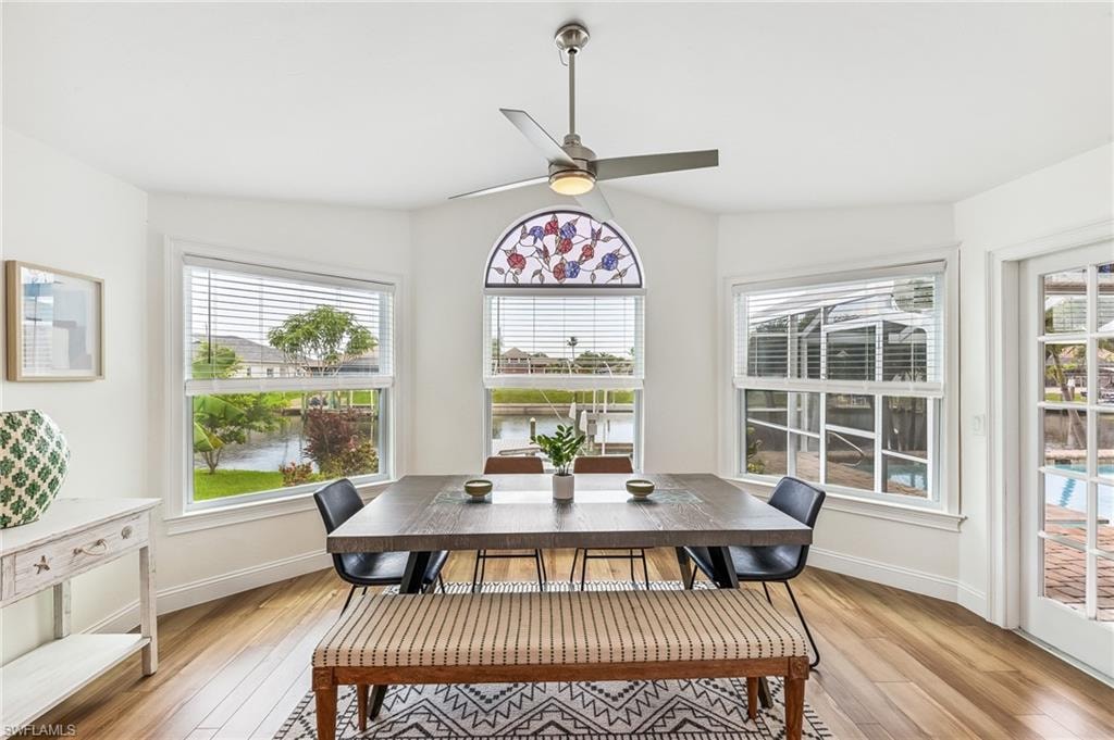 Dining room with light wood-type flooring and a ceiling fan