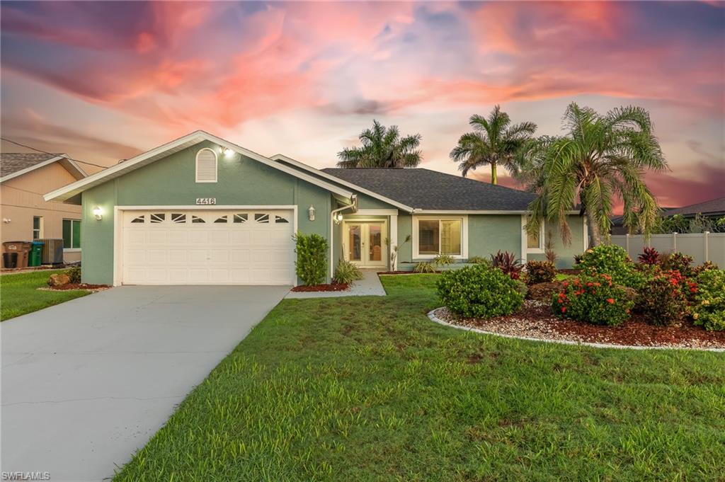 Ranch-style house featuring french doors, an attached garage, concrete driveway, and stucco siding