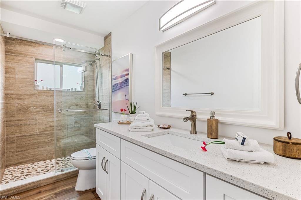 Full bathroom featuring vanity and a shower stall