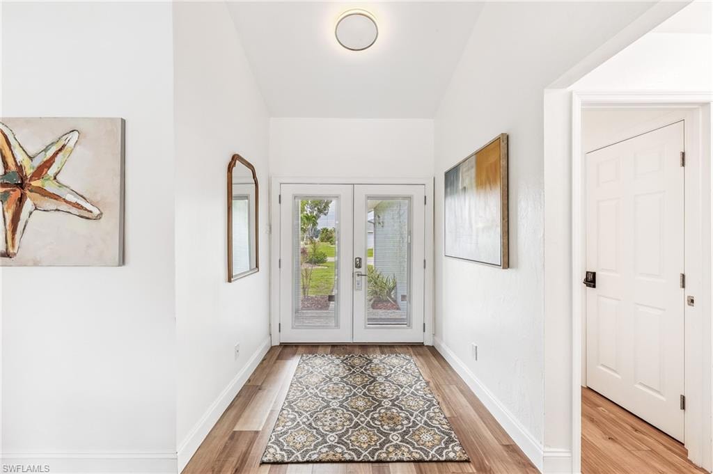 Entryway featuring light wood-style flooring and french doors