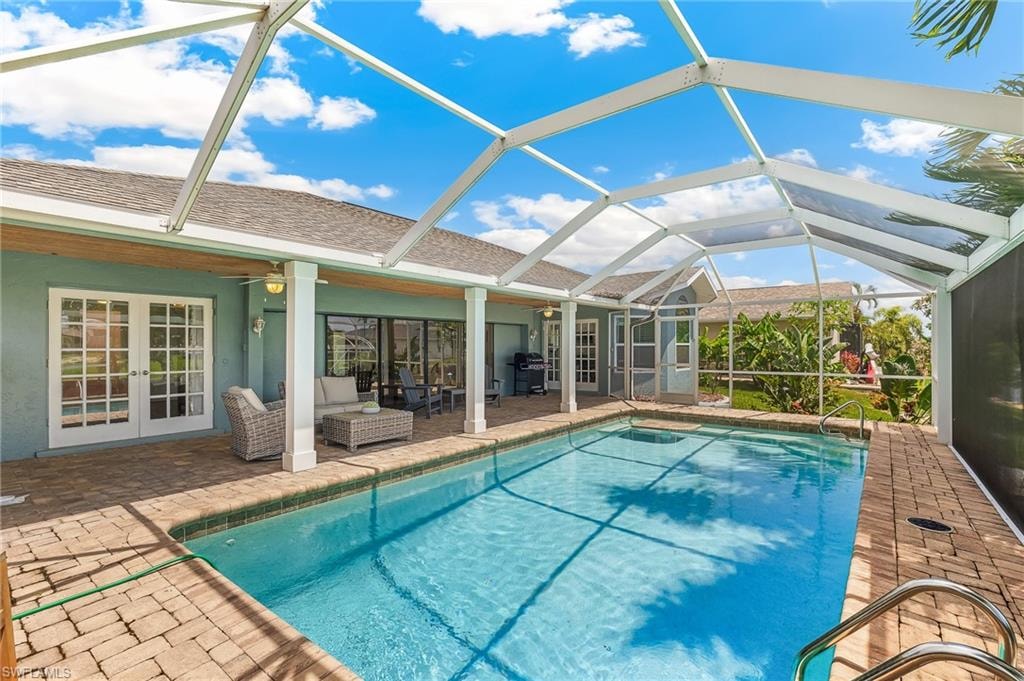 Outdoor pool with french doors, a patio area, area for grilling, and ceiling fan