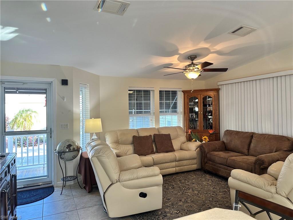 Tiled living room with a ceiling fan