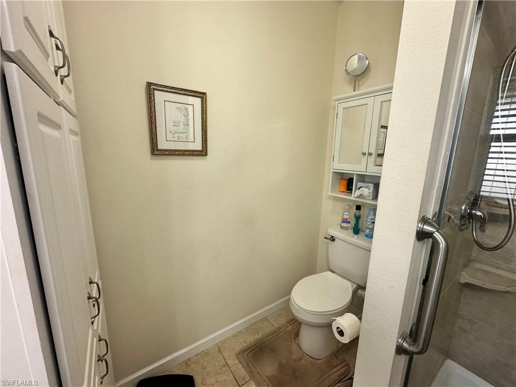 Full bathroom featuring a stall shower and light tile patterned flooring